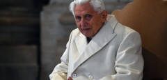 Pope Emeritus Benedict XVI arrives at St Peter's basilica before the opening of the "Holy Door" by Pope Francis to mark the start of the Jubilee Year of Mercy, on December 8, 2015 in Vatican. Pope Francis marks the start of an extraordinary Jubilee year for the world's 1.2 billion Catholics by opening a "Holy Door" in the walls of St Peter's basilica. At 9.30 am (0830 GMT), the Argentinian pontiff will pronounce the words "Aperite mihi Porta Iustitiae" -- Latin for "open to me the gates of justice" -- and the door, which is normally bricked up, will be opened.    AFP PHOTO / VINCENZO PINTO (Photo by VINCENZO PINTO / AFP)