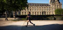 A man jogs on a sunny day at the Tuileries garden on May 5, 2016 in Paris. (Photo by LIONEL BONAVENTURE / AFP)