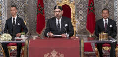 This handout picture provided by the Moroccan Royal Palace on July 29, 2019 shows Morocco's King Mohammed VI (C) delivering a speech marking the 20th anniversary of his accession to the throne, with his brother Prince Moulay Rachid (R) and son Prince Moulay Hassan (L) seated alongside him, in the northern city of Tetouan overlooking the Mediterranean. (Photo by - / MAP / AFP) / == RESTRICTED TO EDITORIAL USE - MANDATORY CREDIT "AFP PHOTO /HO/ MOROCCAN ROYAL PALACE" - NO MARKETING NO ADVERTISING CAMPAIGNS - DISTRIBUTED AS A SERVICE TO CLIENTS ==