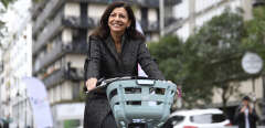 Mayor of Paris Anne Hidalgo rides a new "Velib Metropole" bicycles during its launch at Bassin de la Villette in Paris on October 25, 2017. - The bicycles will be available in two versions: green - manual and blue - electric. (Photo by ERIC FEFERBERG / AFP)