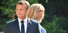 French President Emmanuel Macron (L) and his wife Brigitte Macron (R) wait for the arrival of the Russian President, at the French President' summer retreat of the Bregancon fortress on the Mediterranean coast, near the village of Bormes-les-Mimosas, southern France, on August 19, 2019, for talks days before the G7 Summit. (Photo by GERARD JULIEN / AFP)