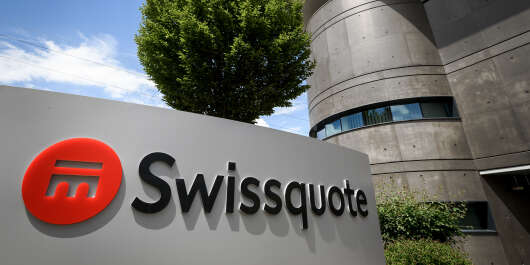 A sign of Swiss banking group Swissquote specialized in online financial and trading services is seen at its heaquarters on May 21, 2018 in Gland, western Switzerland. (Photo by Fabrice COFFRINI / AFP)