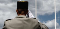An officer of the French Army salutes near the flag of the United States  during a ceremony in Vierville-sur-Mer, northwestern France, on June 6, 2020, as part of D-Day commemorations marking the 76th anniversary of the World War II Allied landings in Normandy. - For the first time in 75-years, official commemorations marking the 1944 D-Day landings, which marked the beginning of the end of Nazi Germany, have been canceled except for a limited gathering of representatives from nine countries for a short ceremony. Many of this year’s events will be relayed by live stream to the dwindling number of elderly former soldiers who took part in the allied landings along 80kms (50miles) of beaches. (Photo by Sameer Al-DOUMY / AFP)