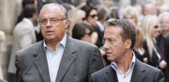 French TV producer Gerard Louvin (L), flanked by his husband Daniel Moyne, arrives to attend the funeral of French actor and filmmaker Jean-Claude Brialy at Saint-Louis-en-l'Ile's church in Paris on June 4, 2007. - French prosecutors said on February 9, 2021 they had opened an investigation into accusations of child sexual assault against a prominent television producer and his husband, the latest sexual assault case to rock the intellectual elite. Gerard Louvin, who has produced some of the most popular shows on French television over the last decades, and his husband Daniel Moyne are being investigated for raping and complicity in raping minors, Paris prosecutors said. (Photo by Olivier Laban-Mattei / AFP)
