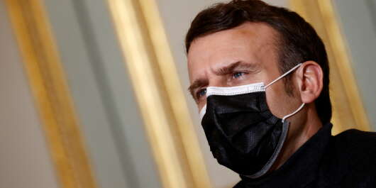French President Emmanuel Macron, wearing a protective face mask, attends a video-conference meeting with World Health Organization (WHO) Director-General Tedros Adhanom Ghebreyesus (unseen) at the Elysee Palace in Paris amid the coronavirus disease (COVID-19) pandemic on February 8, 2021. (Photo by CHRISTIAN HARTMANN / POOL / AFP)