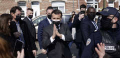 French president Emmanuel Macron (C) leaves after visit a pharmacy in Valenciennes, France, 23 March 2021. 
