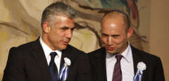 Israeli politician Yair Lapid (L), leader of the Yesh Atid party, speaks to Naftali Bennett, head of the Israeli hardline national religious party the Jewish Home during a reception marking the opening of the 19th Knesset (Israeli parliament) on February 5, 2013 in Jerusalem. AFP PHOTO/GALI TIBBON (Photo by GALI TIBBON / AFP)