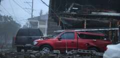 NEW ORLEANS, LOUISIANA - AUGUST 29: Vehicles are damaged after the front of a building collapsed during Hurricane Ida on August 29, 2021 in New Orleans, Louisiana. Ida made landfall earlier today southwest of New Orleans.   Scott Olson/Getty Images/AFP
== FOR NEWSPAPERS, INTERNET, TELCOS & TELEVISION USE ONLY ==