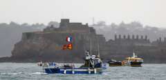 (FILES) In this file photo taken on May 6, 2021 French fishing boats protest in front of the port of Saint Helier off the British island of Jersey to draw attention to what they see as unfair restrictions on their ability to fish in UK waters after Brexit. - French government called for 169 vessels to be granted definitive access to British waters off Jersey before their existing temporary licences expired on September 30, 2021. (Photo by Sameer Al-DOUMY / AFP)