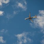 worms eye view of airplane flying on sky