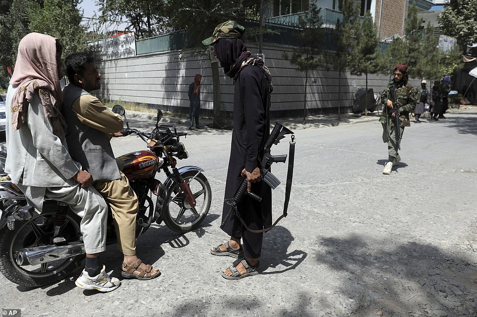 Taliban fighters stand guard at a checkpoint in the Wazir Akbar Khan neighborhood in the city of Kabul, Afghanistan