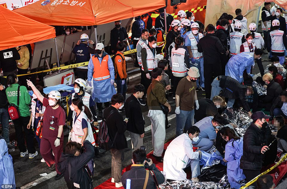 Emergency workers try to keep casualties warm as they wait to receive medical attention