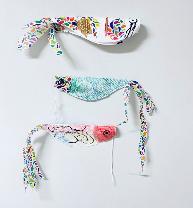 Three multicolored Koinobris (Japanese fish kites) displayed against a white background Three multicolored Koinobris (Japanese fish kites) displayed against a white background