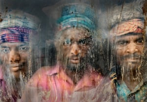 Three gravel workmen are looking through the window at work place Chittagong, Bangladesh