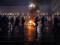 Demonstrators clash with Riot Police during the protest against the lockdown in Piazza Castello on October 26, 2020 in Turin, Italy. The protest is organized to protest against the blockade to restaurant and bars and curfew imposed in the Piedmont Region and by the Italian Government of the evening lockdown which will start from today at 6pm to contain the coronavirus pandemic. (Photo by Mauro Ujetto/NurPhoto via Getty Images)