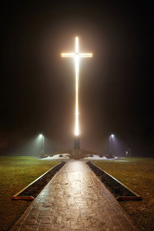 The tallest illuminated, self-supporting cross in the Western Hemisphere stands perched above the city on a foggy night from its location behind St. Basil's Secondary School in Sault Ste. Marie, ON - tfavretto