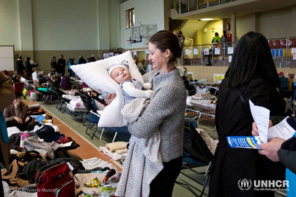 Valentina, a refugee from Ukraine, holds her 2-month-old nephew.