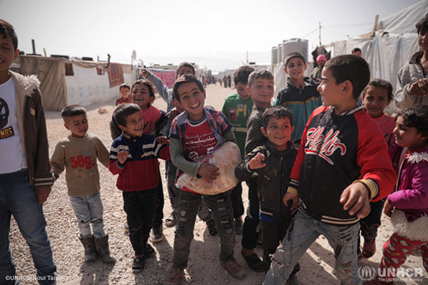 Young Syrian refugee children play together at an informal settlement in Libya.