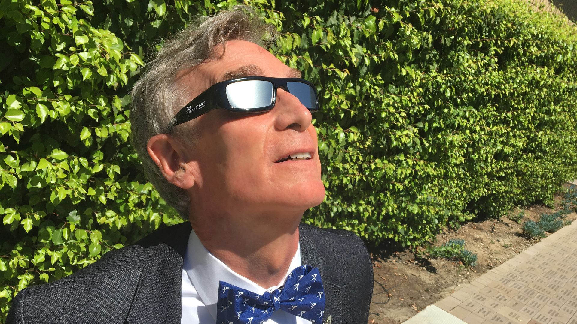 A photo of Bill Nye the science guy in eclipse glasses