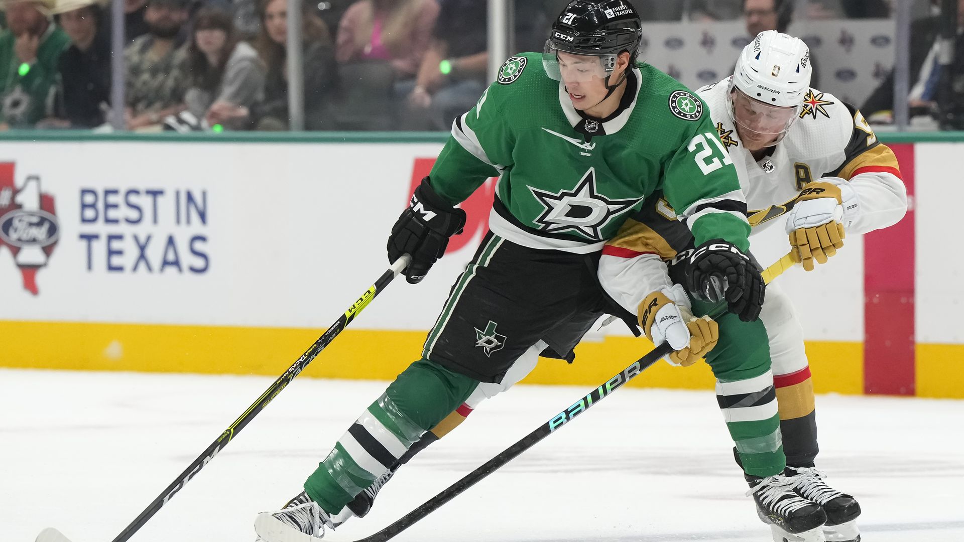 Dallas Stars Jason Robertson competes for the puck with Vegas Golden Knights Jack Eichel