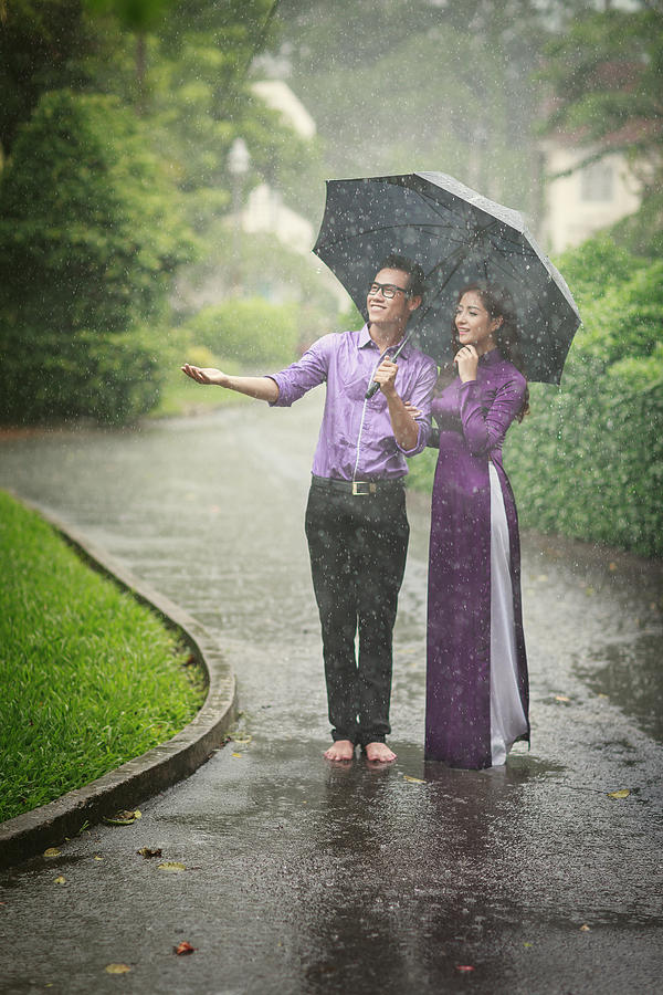 Vietnamese Couple In Traditional Clothes Ao Dai With Love Mood in the rain  Photograph by Huynh Thu - Fine Art America