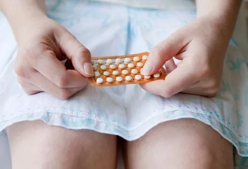 woman with blister pack of birth control pills
