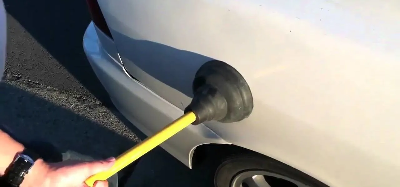 Image result for fixing a dent in a car with a plunger