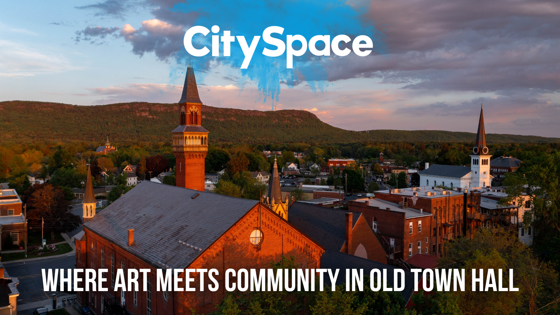 Scenic view of historic old town hall building with mountain landscape in the background. CitySpace Where Art Meets Community in Old Town Hall
