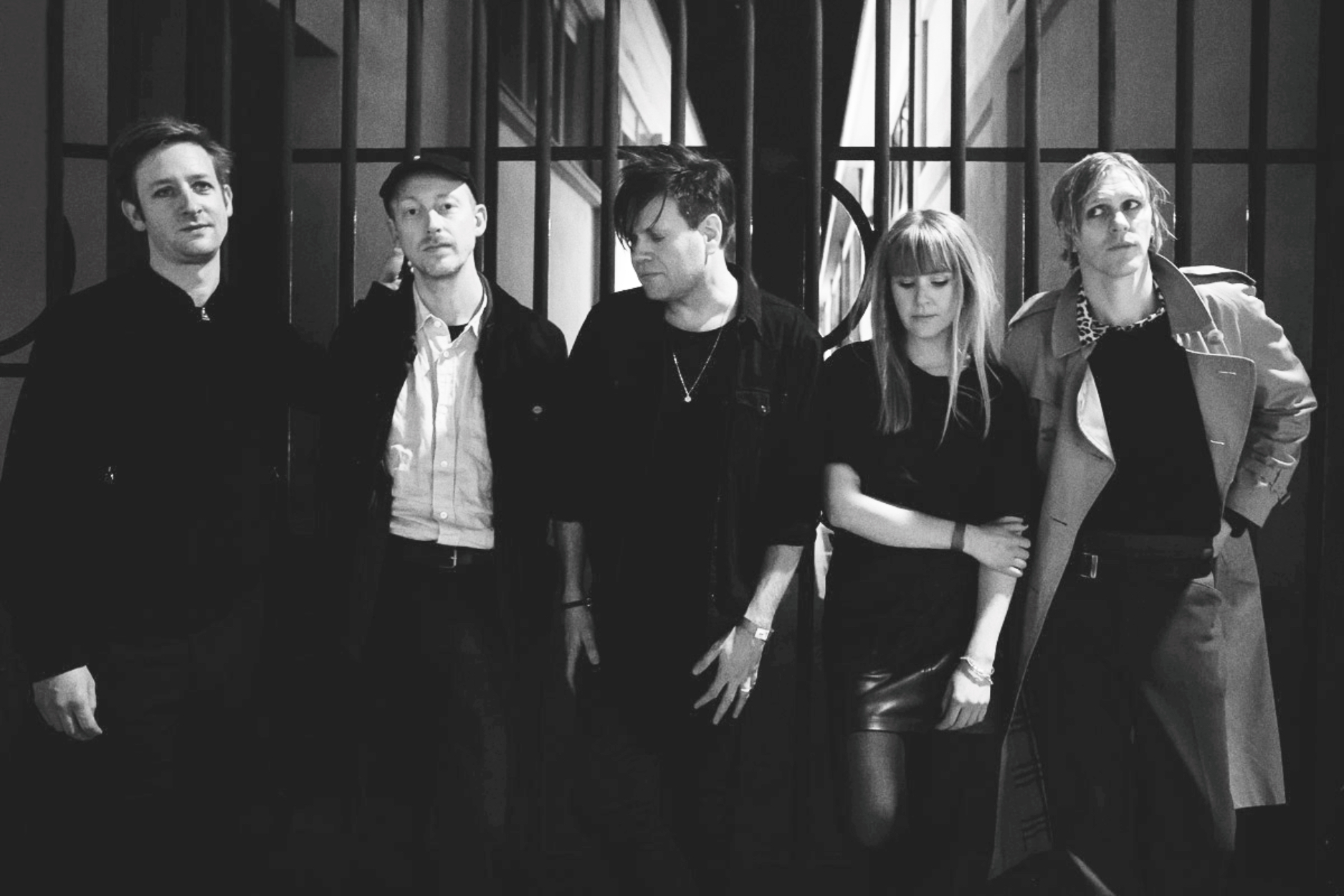 a group of people standing in front of a window