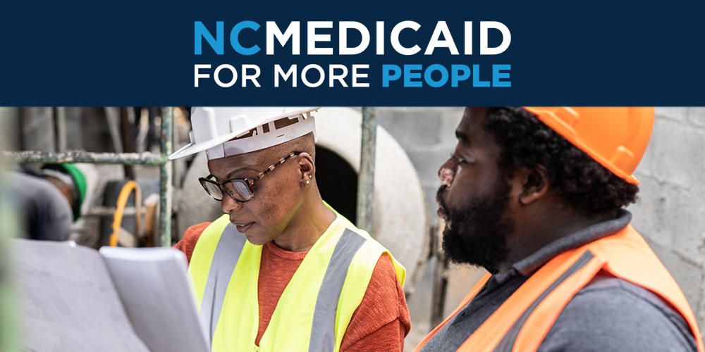 Two people working in construction.