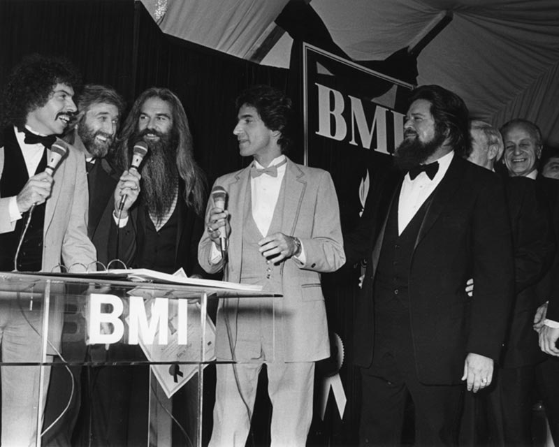 Joe Bonsall, Duane Allen, William Lee Golden, Richard Sterban, Dallas Frazier and Wesley Rose at the 1982 BMI Awards.