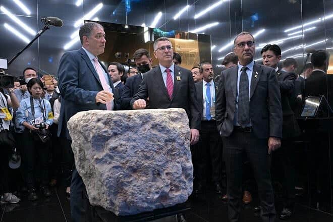 Israeli Foreign Minister Gideon Sa'ar (c) stands behind a stone on display that was part of a fortified tower built by the Hasmoneans in Jerusalem over 2,000 years ago, at the Israel Pavilion at Expo 2025 in Osaka, Japan, May 15, 2025. Credit: Shlomi Amsalem/MFA. Israeli Foreign Minister Gideon Sa'ar (c) stands behind a stone on display that was part of a fortified tower built by the Hasmoneans in Jerusalem over 2,000 years ago, at the Israel Pavilion at Expo 2025 in Osaka, Japan, May 15, 2025. Credit: Shlomi Amsalem/MFA.