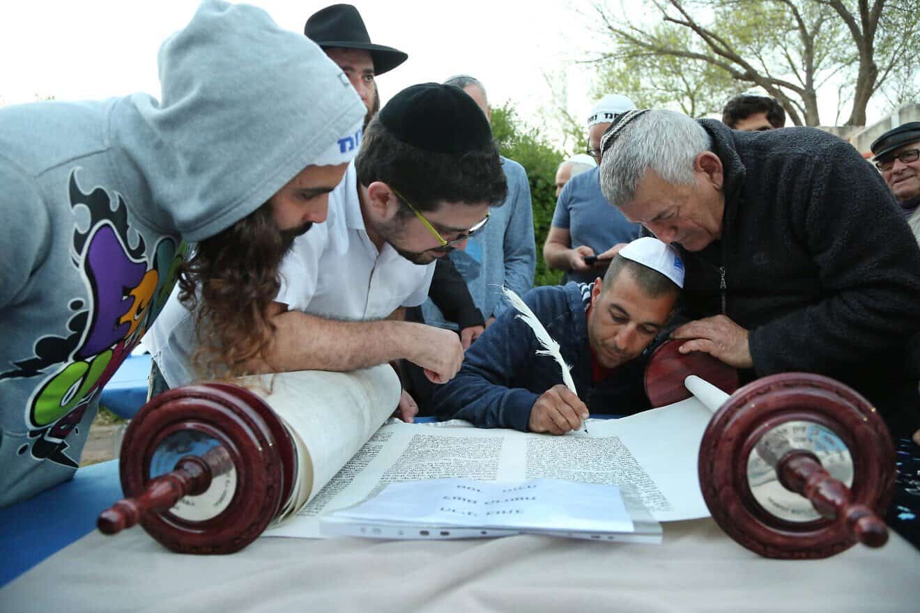 A few people are honored with writing the last letters of a new Torah scroll for a synagogue in Haniel, Israel, on Oct. 19, 2016. Photo by Chen Leopold/Flash90. A few people are honored with writing the last letters of a new Torah scroll for a synagogue in Haniel, Israel, on Oct. 19, 2016. Photo by Chen Leopold/Flash90.