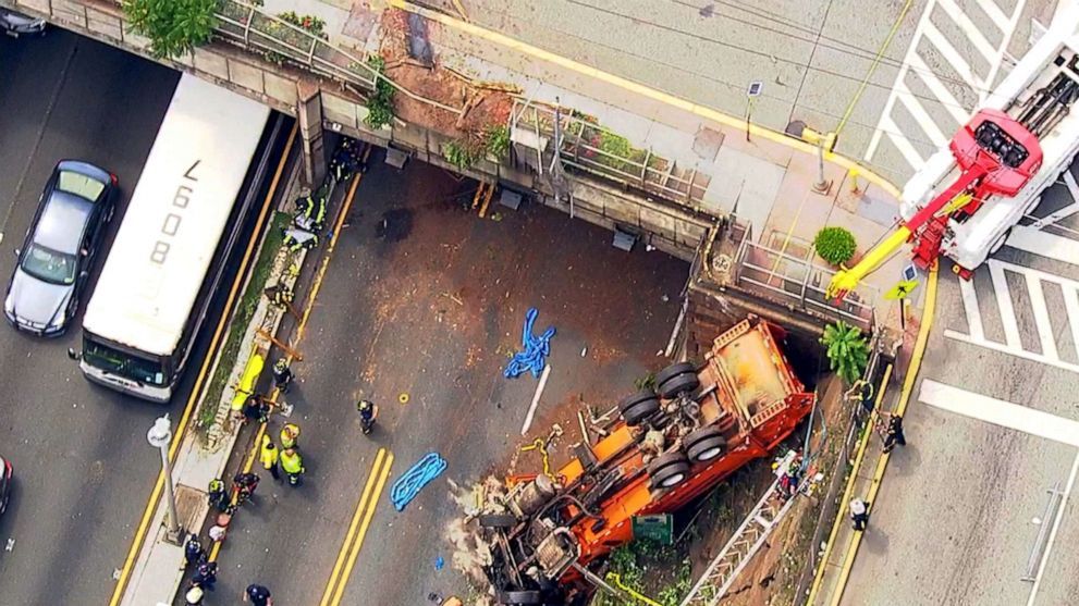 Garbage truck overturns onto highway, 12 injured