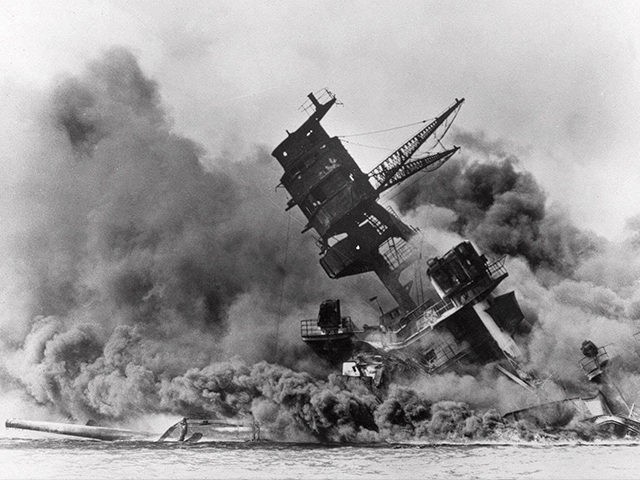 Smoke rises from the battleship USS Arizona as it sinks during a Japanese surprise attack on Pearl Harbor, Hawaii. (AP File Photo)