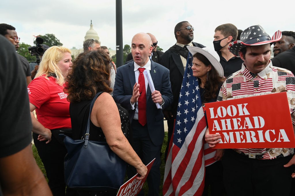 Matt Braynard(C), the rally organizer and executive director of Look Ahead America speaks to a supporter as demonstrators gather for the Justice for J6 rally in Washington, DC, on September 18, 2021, in support of the pro-Trump rioters who ransacked the US Capitol on January 6, 2021. - Washington was on high alert for the rally with security forces better prepared to avoid a repeat of the January 6 attack on the Capitol. US Capitol police said they have no indication of a specific plot associated with the rally, but warned in a news conference there had been some threats of violence, with a counter-rally scheduled to take place nearby. (Photo by ROBERTO SCHMIDT / AFP) (Photo by ROBERTO SCHMIDT/AFP via Getty Images)