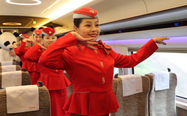 On the first train the steward gave the passengers a joyous dance. Pingdu city, Shandong Province, China, 26 November 2020.- PHOTOGRAPH BY Costfoto /...