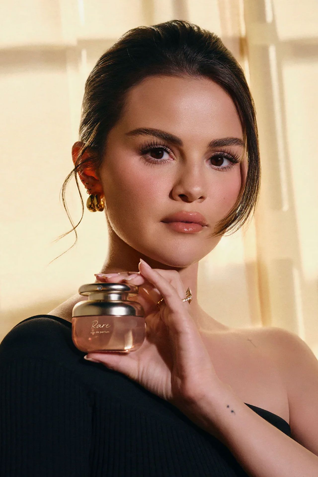 Image may contain Selena Gomez Adult Person Head Face Photography Portrait Bottle Cosmetics and Perfume