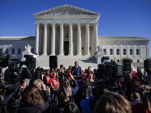 Ken Paxton, Texas attorney general, speaks to a crowd of reporters in front of the Supreme Court.