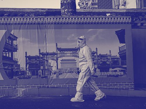 In Beijing, an epidemic-control worker walks down the street, on December, 4, 2022.