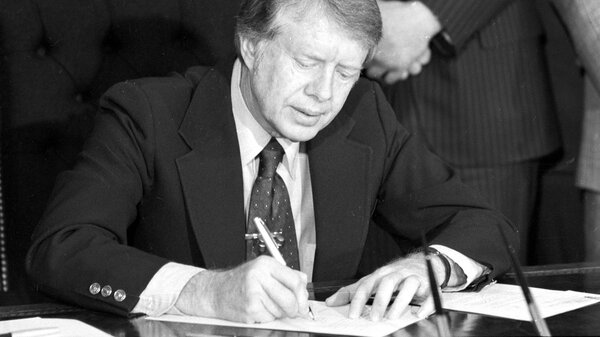 President Jimmy Carter signs emergency natural gas legislation in the Oval Office of the White House in Washington, D.C., on Feb. 2, 1977. An oil crisis contributed to a period of double-digit inflation in the 1970s.
