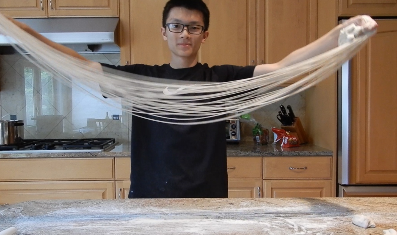 A Photograph of Peter Looi Pulling Noodles