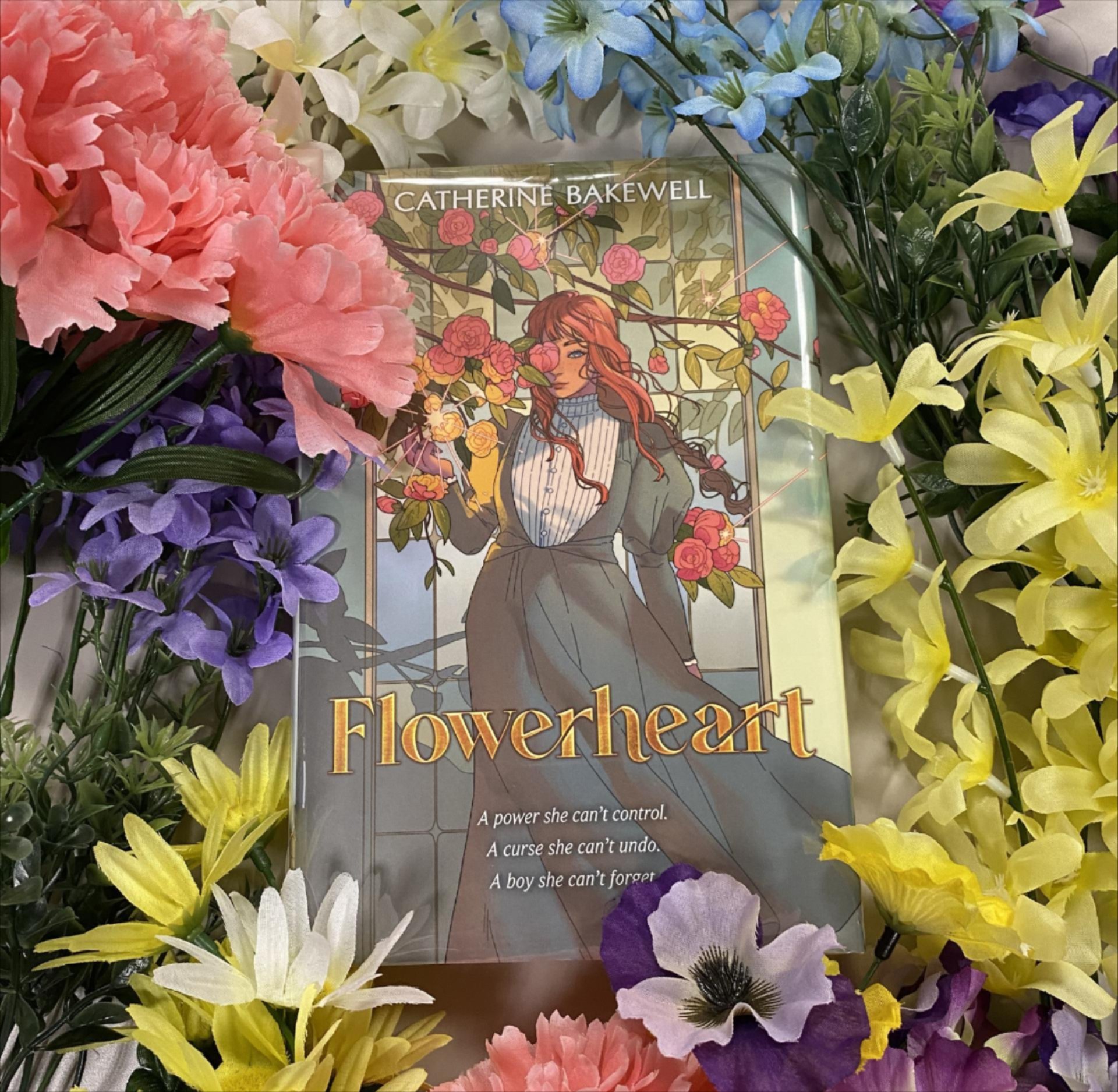 book with illustrated cover surrounded by flowers