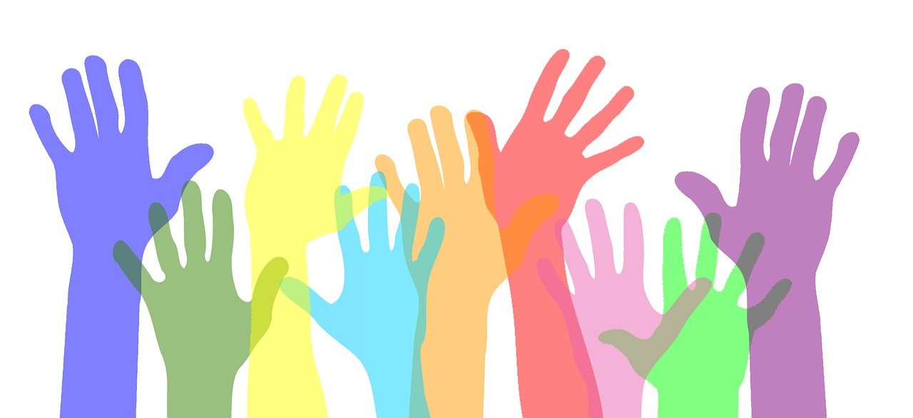 colorful hands raised to volunteer