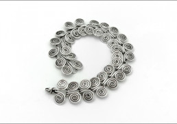 A silver spiral bracelet on white background