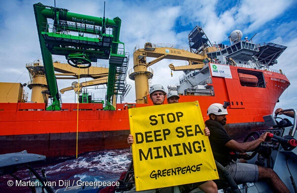 Donate now! Greenpeace International activists holding a Stop Deep Sea Mining! sign