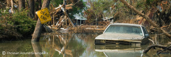We can't keep living like this. Give now. Photo: Wreckage after Hurricane Katrina.
