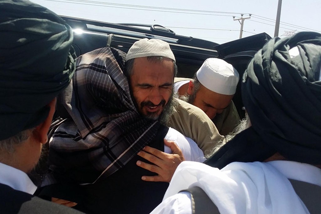 Senior Taliban figure Mohammad Nabi Omari (C-facing) being welcomed at an undisclosed location in Qatar following his release from Guantanamo Bay