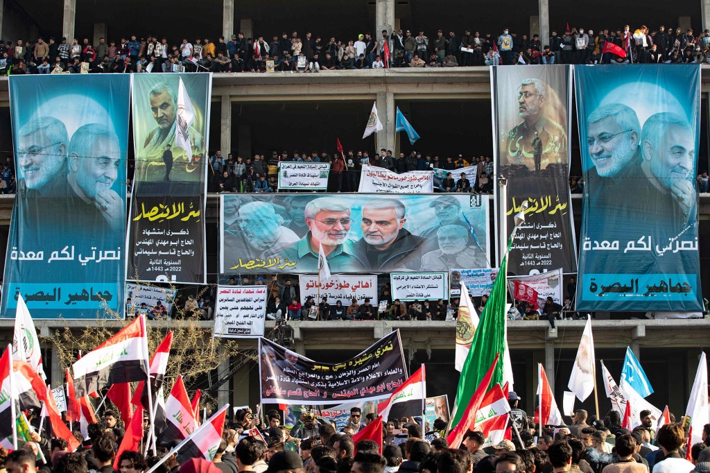 A crowd gathers during commemorations marking the second anniversary of the killing of top Iranian commander Qasem Soleimani and Iraqi commander Abu Mahdi al-Muhandis (posters), in the southern Iraqi city of Basra, on January 8, 2022.