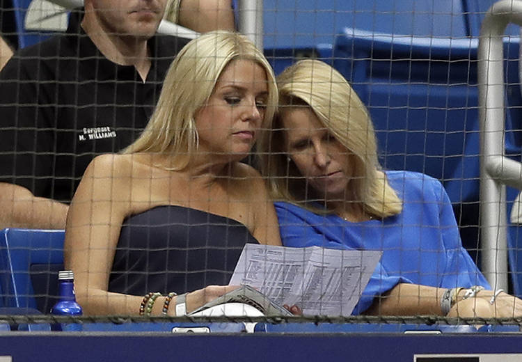 Florida Attorney General Pam Bondi, left, watches a baseball game between the Tampa Bay Rays and the New York Yankees on Saturday in St. Petersburg, Fla. (Chris O'Meara/AP)